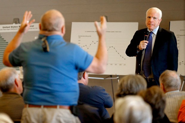 Sen. John McCain, R-Ariz., listens during a town hall in Sun Lakes, Ariz. McCain defended his proposed immigration overhaul to an angry crowd in suburban Arizona.