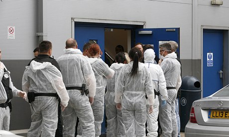Immigration officials prepare to enter factory