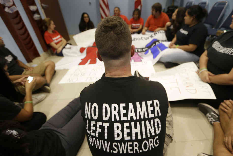 Demonstrators supporting an immigration overhaul stage a sit-down protest at the offices of Rep. Mario Diaz-Balart, R-Fla., on Oct. 11.