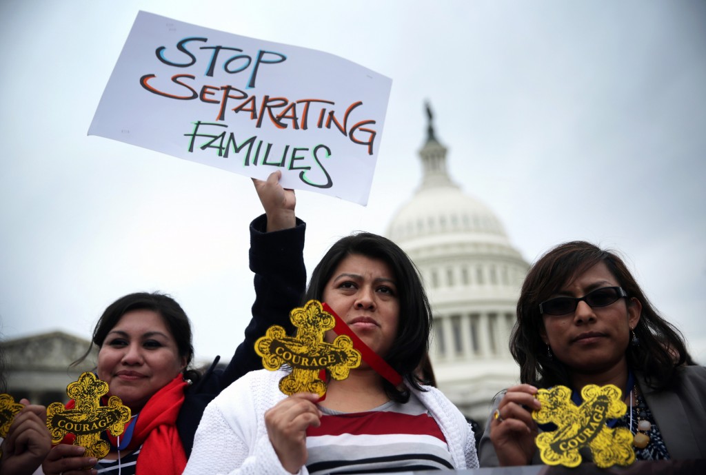  Natividad Gonzalez (C) of Clanton, Ala., and other immigration reform activists holds signs and "Badges of Courage" during a news conference at the east front of the U.S. Capitol March 11, 2014 on Capitol Hill in Washington, D.C. Photo by Alex Wong/Getty Images