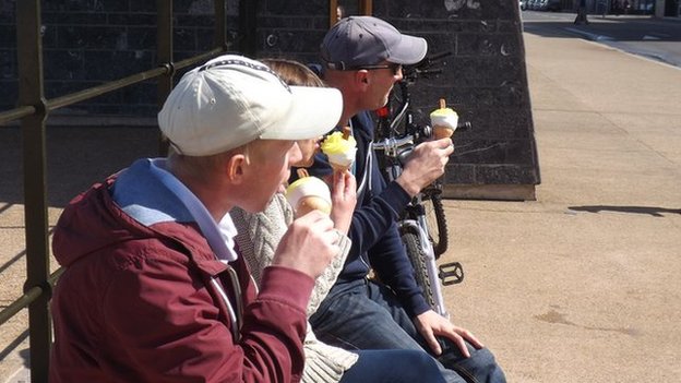Visitors to Redcar enjoy a lemon top on the seafront 