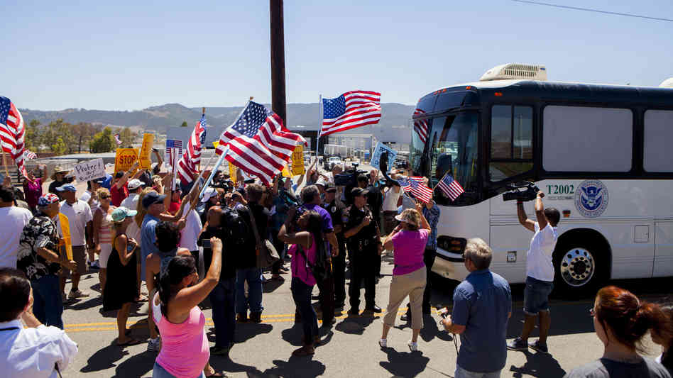 Protesters block the arrival of immigrant detainees who were scheduled to be processed at the Murrieta Border Patrol station in California on Tuesday.