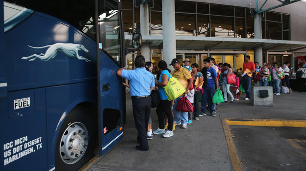 Immigrants board a bus after being released from U.S. Border Patrol detention in Texas last month. An immigration judge says the Obama administration's "fast-tracking" effort means many people go into court without an attorney, opening a door to future problems.
