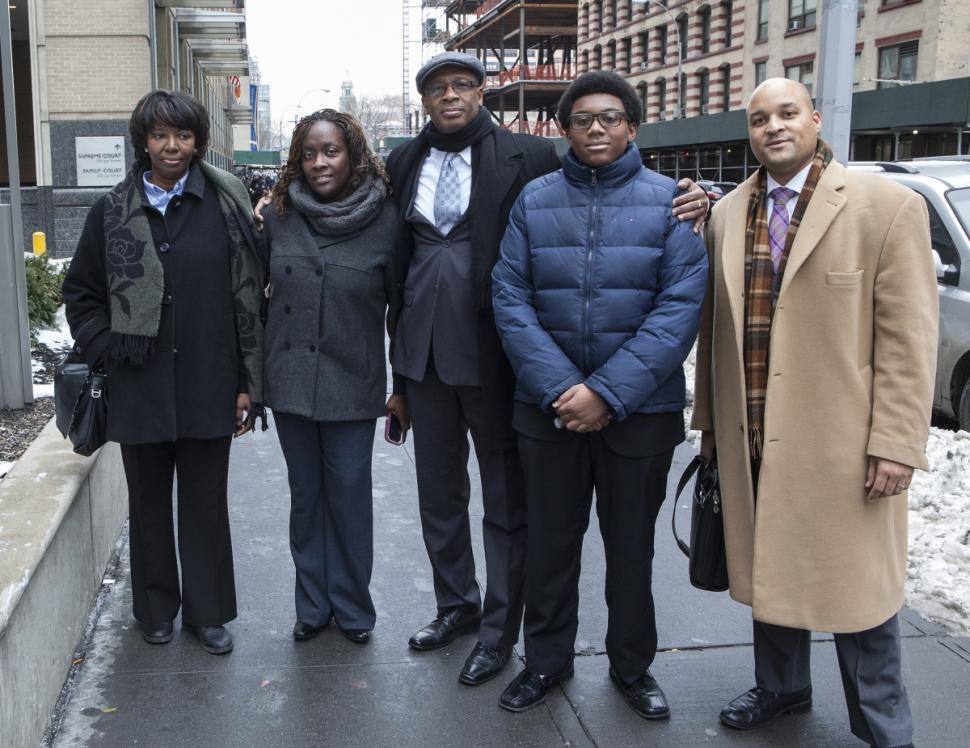 Michael Waithe (center), his son Myles Waithe (right-center), his fiance Karen Garrick (left), his sister Cheryl Waithe (far-left) and lawyer Matthew Smalls pictured together after Waithe's wrongful conviction was tossed out.